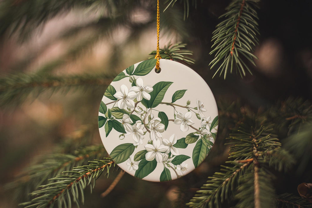 a white ornament hanging from a christmas tree