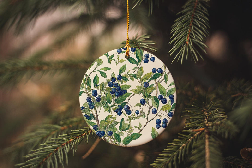 a ceramic ornament hanging from a christmas tree