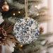 a ceramic ornament hanging from a christmas tree