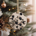 a ceramic ornament hanging from a christmas tree