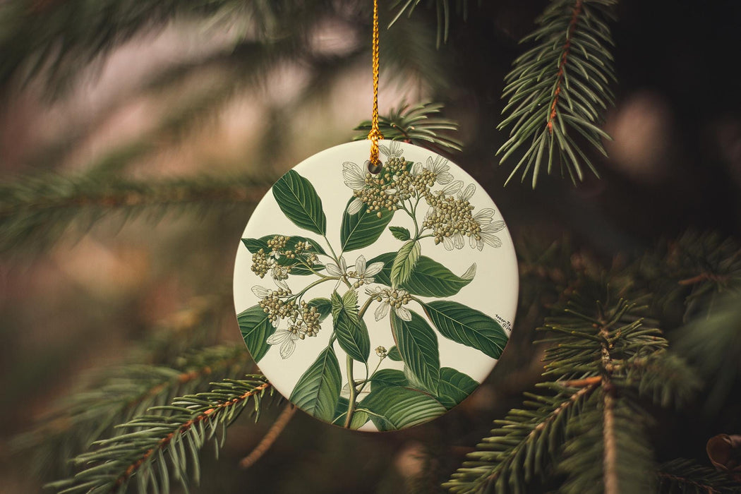a ceramic ornament hanging from a christmas tree