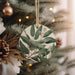 a ceramic ornament hanging from a christmas tree