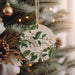 a christmas ornament hanging from a christmas tree
