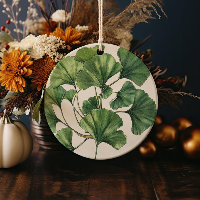 a plate with a green leaf on it next to a vase of flowers