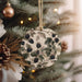 a christmas ornament hanging from a christmas tree