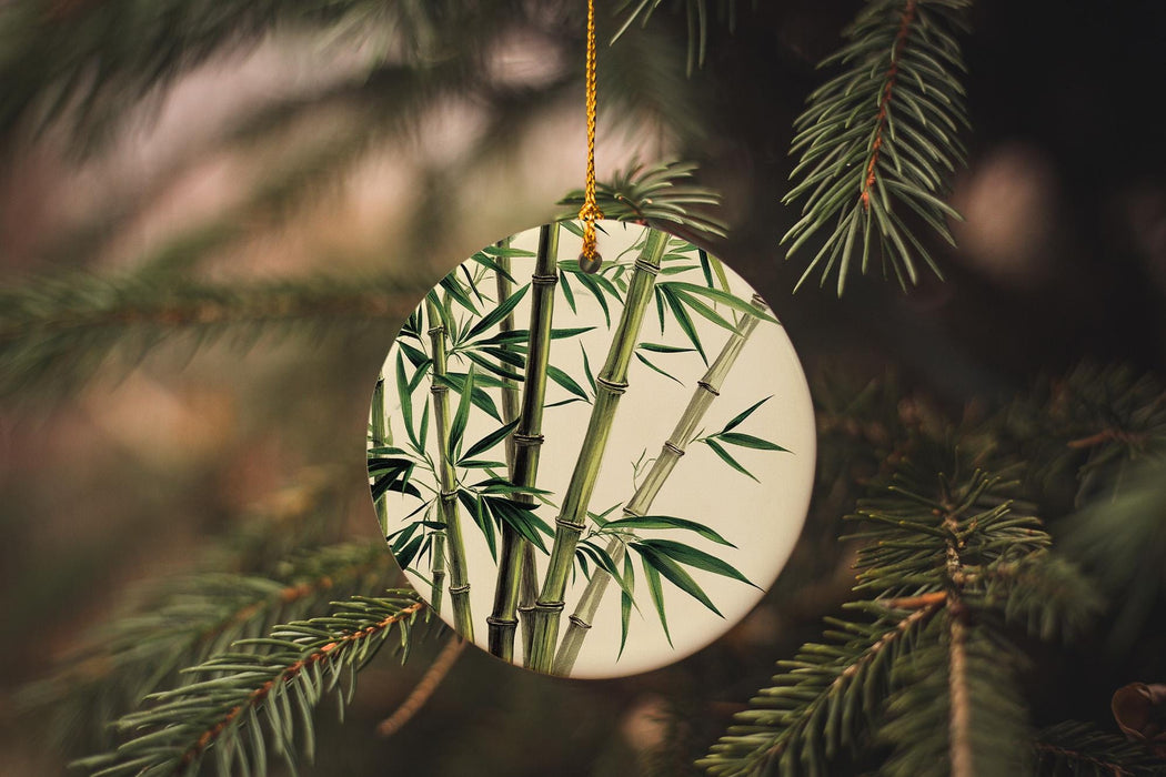 a ceramic ornament hanging from a pine tree