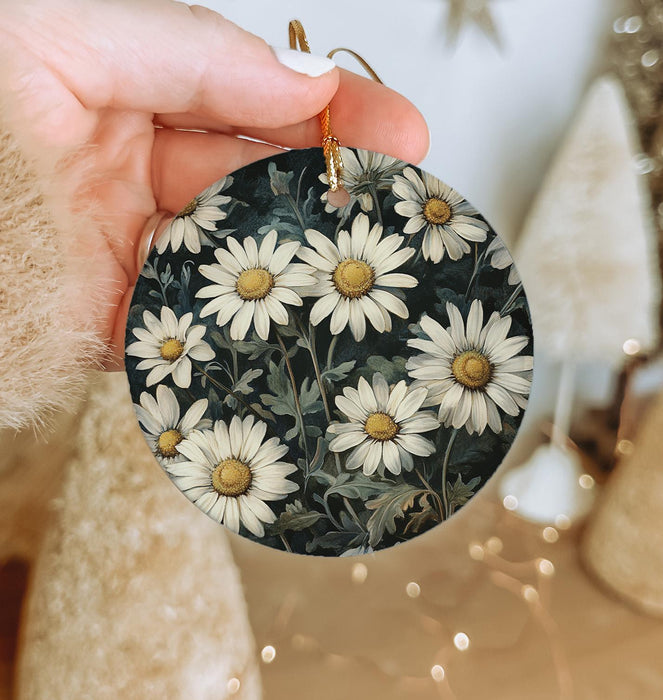a person holding a small ornament with daisies on it