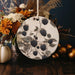 a white plate with blackberries and flowers on it