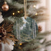 a christmas ornament hanging from a christmas tree