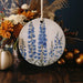 a blue and white floral ornament sitting on a table