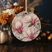 a vase filled with flowers sitting on top of a wooden table