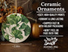 a ceramic ornament with a green leaf design