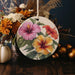 a ceramic ornament decorated with flowers and leaves