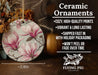 a ceramic ornament with pink flowers on it