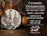 a ceramic ornament with purple flowers on it