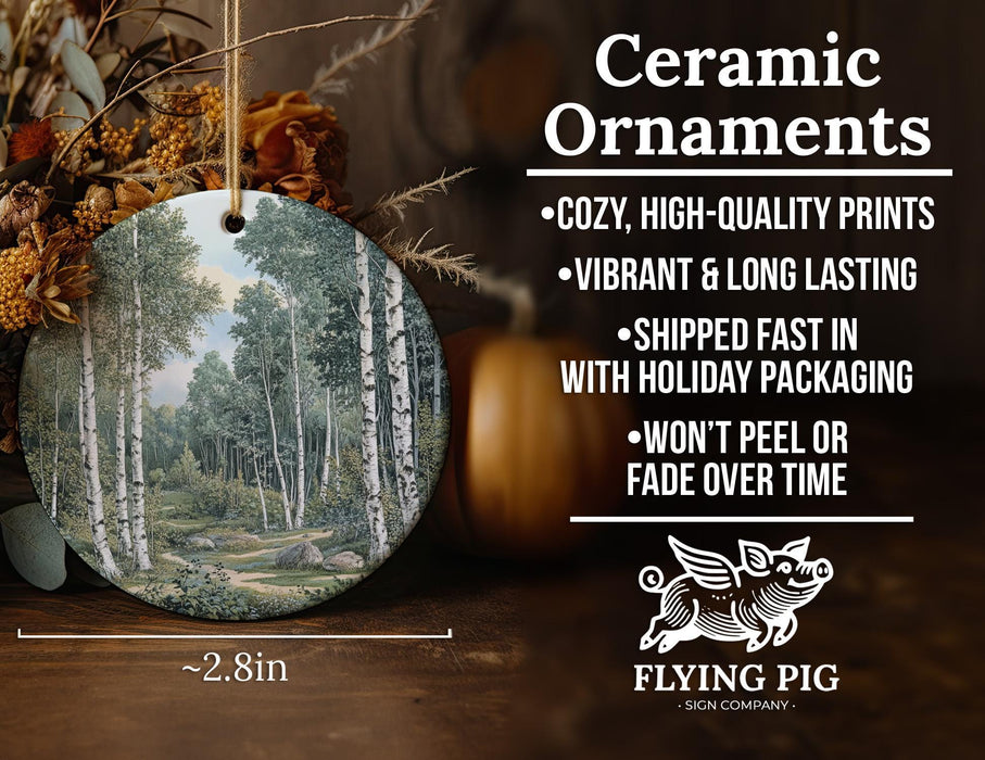 a ceramic ornament with a painting of a forest scene