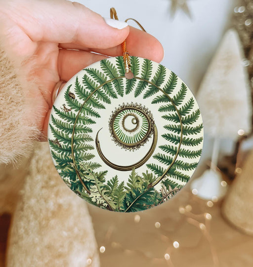 a person holding a christmas ornament in their hand