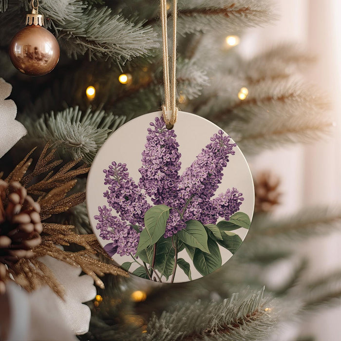 a purple flower ornament hanging from a christmas tree