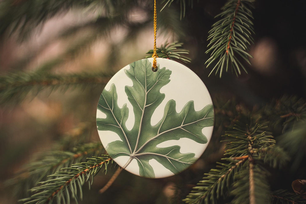 a ceramic ornament hanging from a christmas tree