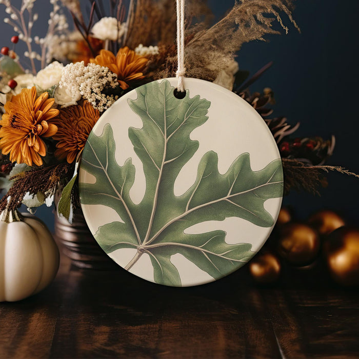a ceramic plate with a green leaf on it