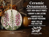 a ceramic ornament with pink flowers on it