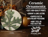 a ceramic ornament with a green leaf on it