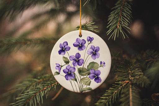 a white ornament with purple flowers hanging from a tree