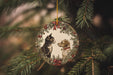 a cat and dog ornament hanging from a christmas tree