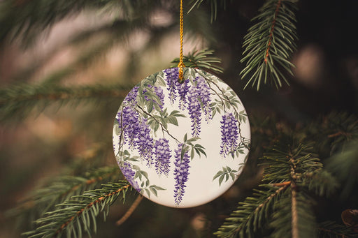 a ceramic ornament with purple flowers hanging from a tree
