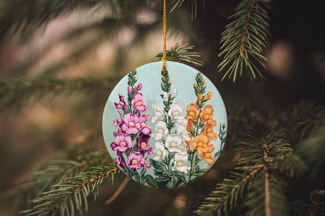 a ceramic ornament hanging from a pine tree