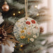 a christmas ornament hanging from a christmas tree