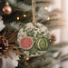 a watermelon ornament hanging from a christmas tree