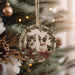 a christmas ornament with two cats on it