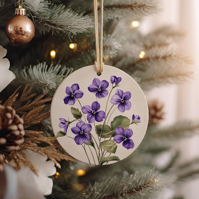 a ceramic ornament hanging from a christmas tree