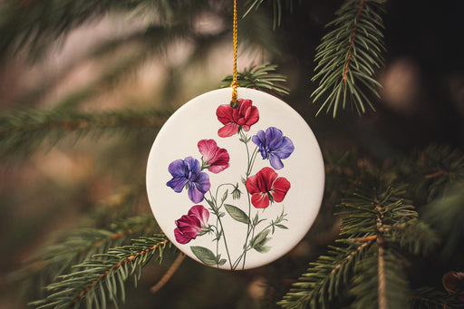 a ceramic ornament with flowers hanging from a tree