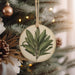a christmas ornament hanging from a christmas tree