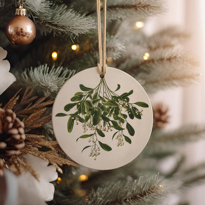 a ceramic ornament hanging from a christmas tree