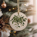 a ceramic ornament hanging from a christmas tree