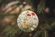 a ceramic ornament hanging from a pine tree