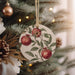 a ceramic ornament hanging from a christmas tree