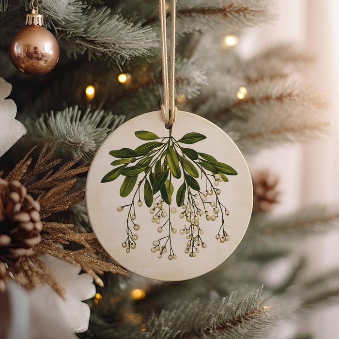 a ceramic ornament hanging from a christmas tree