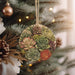 a christmas ornament hanging from a christmas tree