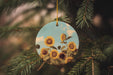 a sunflower ornament hanging from a pine tree