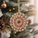 a christmas ornament hanging from a christmas tree