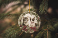 a christmas ornament with two kittens on it