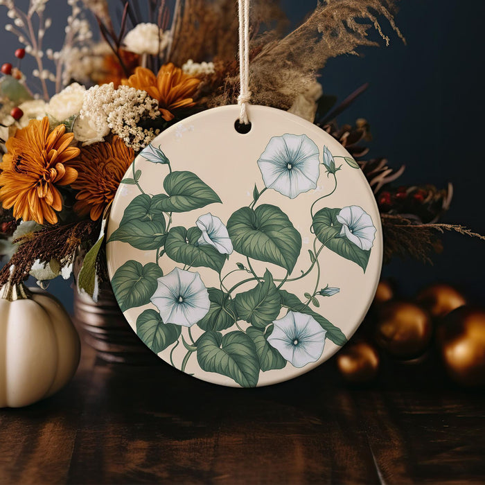 a ceramic ornament decorated with flowers and leaves