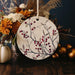 a ceramic ornament decorated with berries and flowers