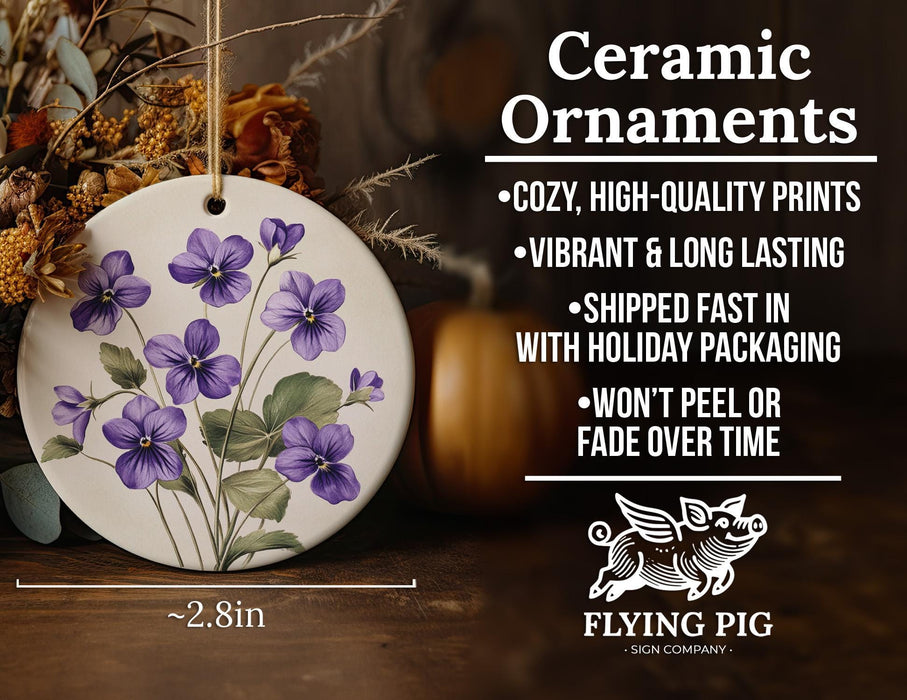 a ceramic ornament with purple flowers on it
