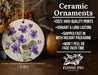a ceramic ornament with purple flowers on it