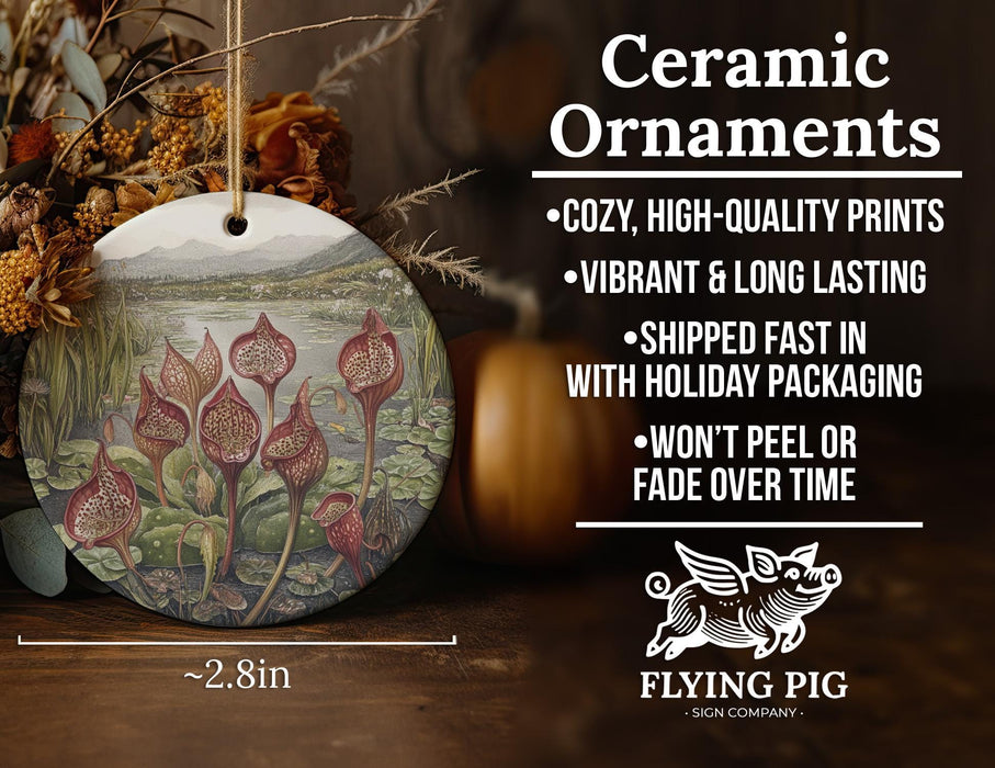 a ceramic ornament with a painting of flowers on it